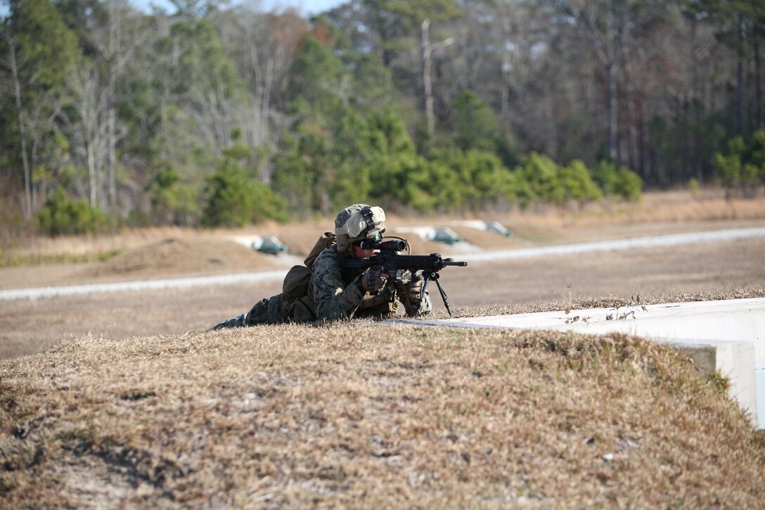 Lance Cpl. Max D. Tackett, rifleman, Company A, Ground Combat Element Integrated Task Force, executes an assault on a simulated enemy position during a fire team collective skills exercise at Range K509, Marine Corps Base Camp Lejeune, North Carolina, Dec. 16, 2014. The Marines utilized the M4 carbine rifle and M16-A4 service rifle, as well as the M27 Infantry Automatic Rifle and M203 grenade launcher. From October 2014 to July 2015, the Ground Combat Element Integrated Task Force will conduct individual and collective skills training in designated combat arms occupational specialties in order to facilitate the standards based assessment of the physical performance of Marines in a simulated operating environment performing specific ground combat arms tasks. (U.S. Marine Corps photo by Cpl. Paul S. Martinez/Released)