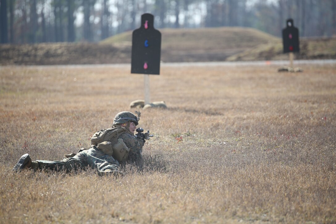 Cpl. Ramses Chavez, rifleman, Company A, Ground Combat Element Integrated Task Force, communicates with teammates during a fire team collective skills exercise at Range K509, Marine Corps Base Camp Lejeune, North Carolina, Dec. 16, 2014. The Marines utilized the M4 carbine rifle and M16A4 service rifle, as well as the M27 Infantry Automatic Rifle and M203 grenade launcher. From October 2014 to July 2015, the Ground Combat Element Integrated Task Force will conduct individual and collective skills training in designated combat arms occupational specialties in order to facilitate the standards based assessment of the physical performance of Marines in a simulated operating environment performing specific ground combat arms tasks. (U.S. Marine Corps photo by Cpl. Paul S. Martinez/Released)