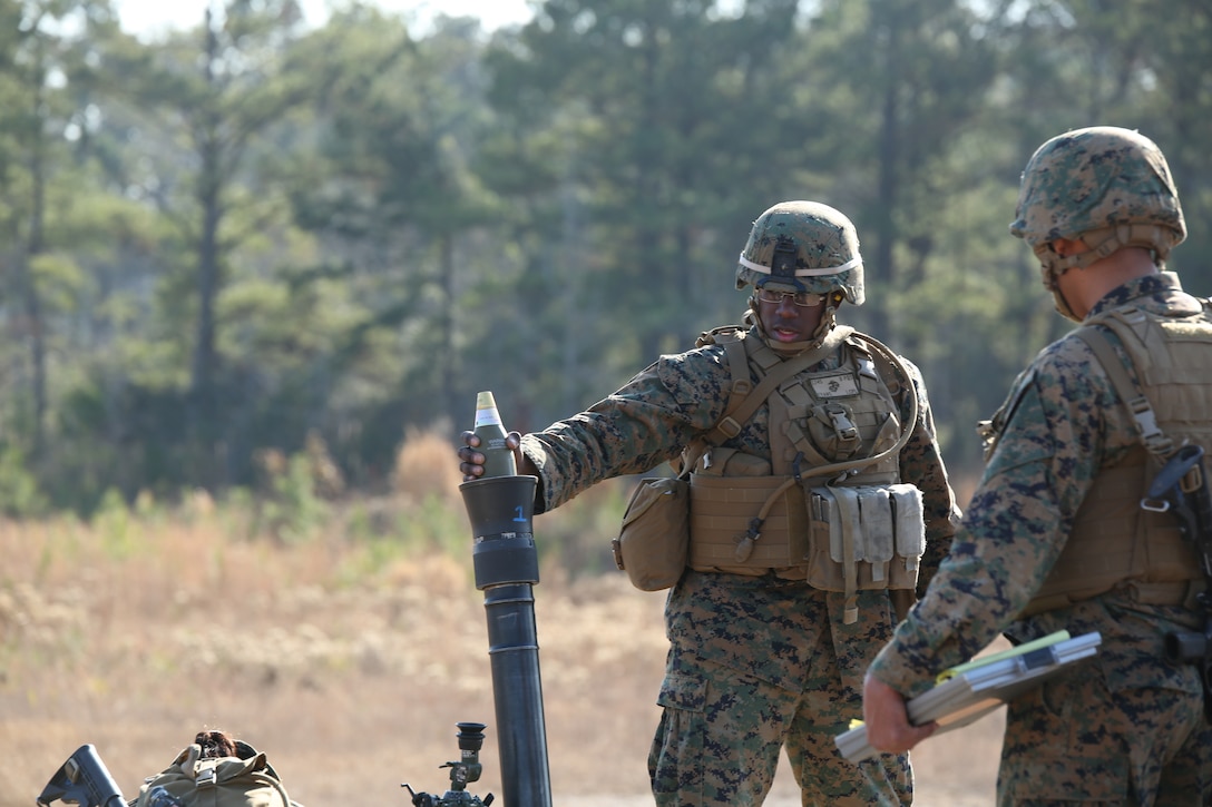 Lance Cpl. Charles E. Evans Jr., mortarman, Mortar Platoon, Weapons Company, Ground Combat Element Integrated Task Force, loads an 81mm mortar system during a field exercise at Range K500, Dec. 16, 2014. From October 2014 to July 2015, the Ground Combat Element Integrated Task Force will conduct individual and collective skills training in designated combat arms occupational specialties in order to facilitate the standards based assessment of the physical performance of Marines in a simulated operating environment performing specific ground combat arms tasks. (U.S. Marine Corps photo by Cpl. Paul S. Martinez/Released)