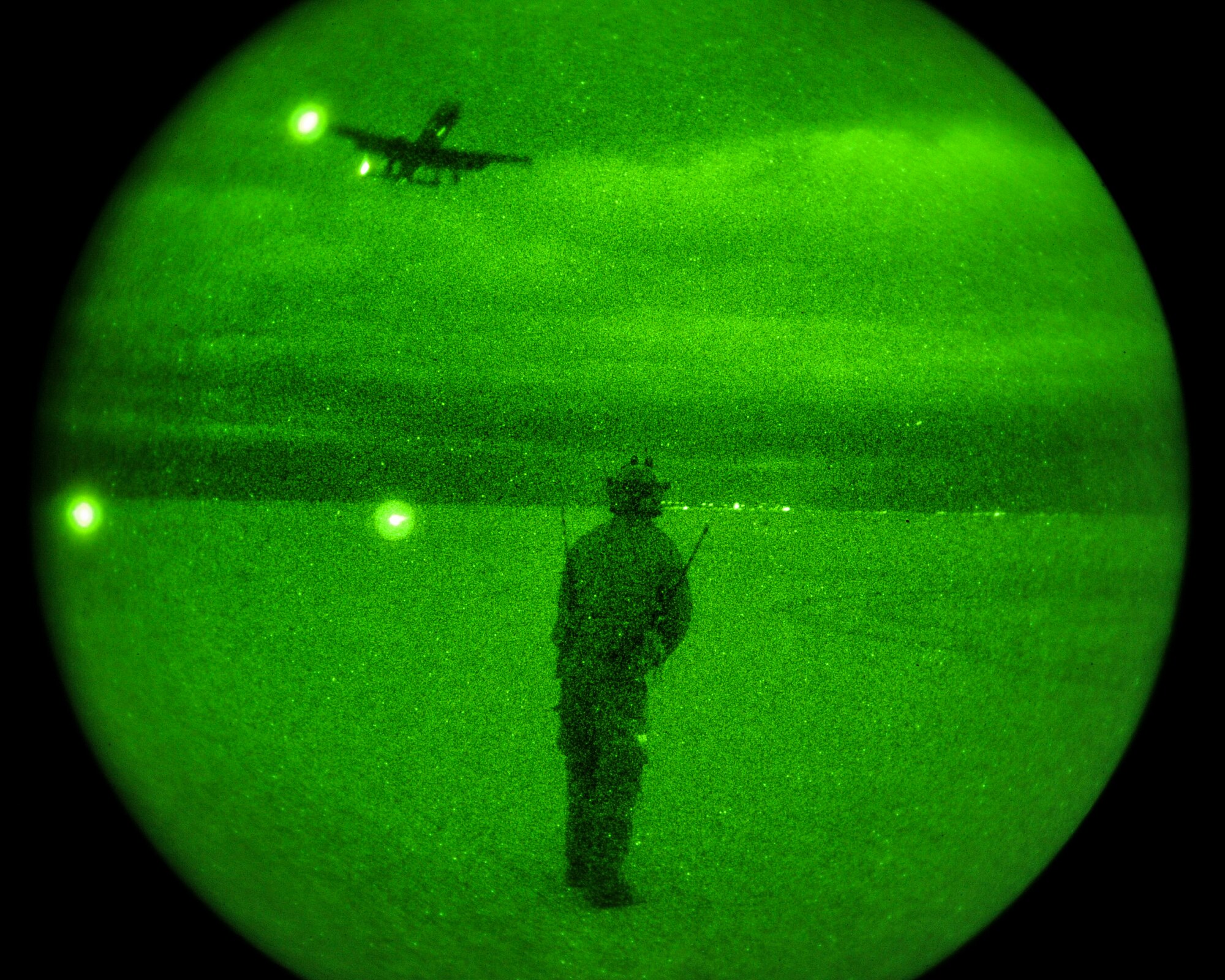 U.S. Air Force 1st Lt. Jesse Galt, 23rd Special Tactics Squadron Gold Team assistant team leader based out of Hurlburt Field, Fla., observes an A-10C Thunderbolt II of the 74th Fighter Squadron, Moody Air Force Base, Ga., approaching a covert landing strip at White Sands Missile Range, N.M., Dec. 4, 2014.  The landing strip was lined with infrared lights that could only be viewed with the aid of a night vision device.  (U.S. Air Force photo by Airman 1st Class Chris Massey/Released)