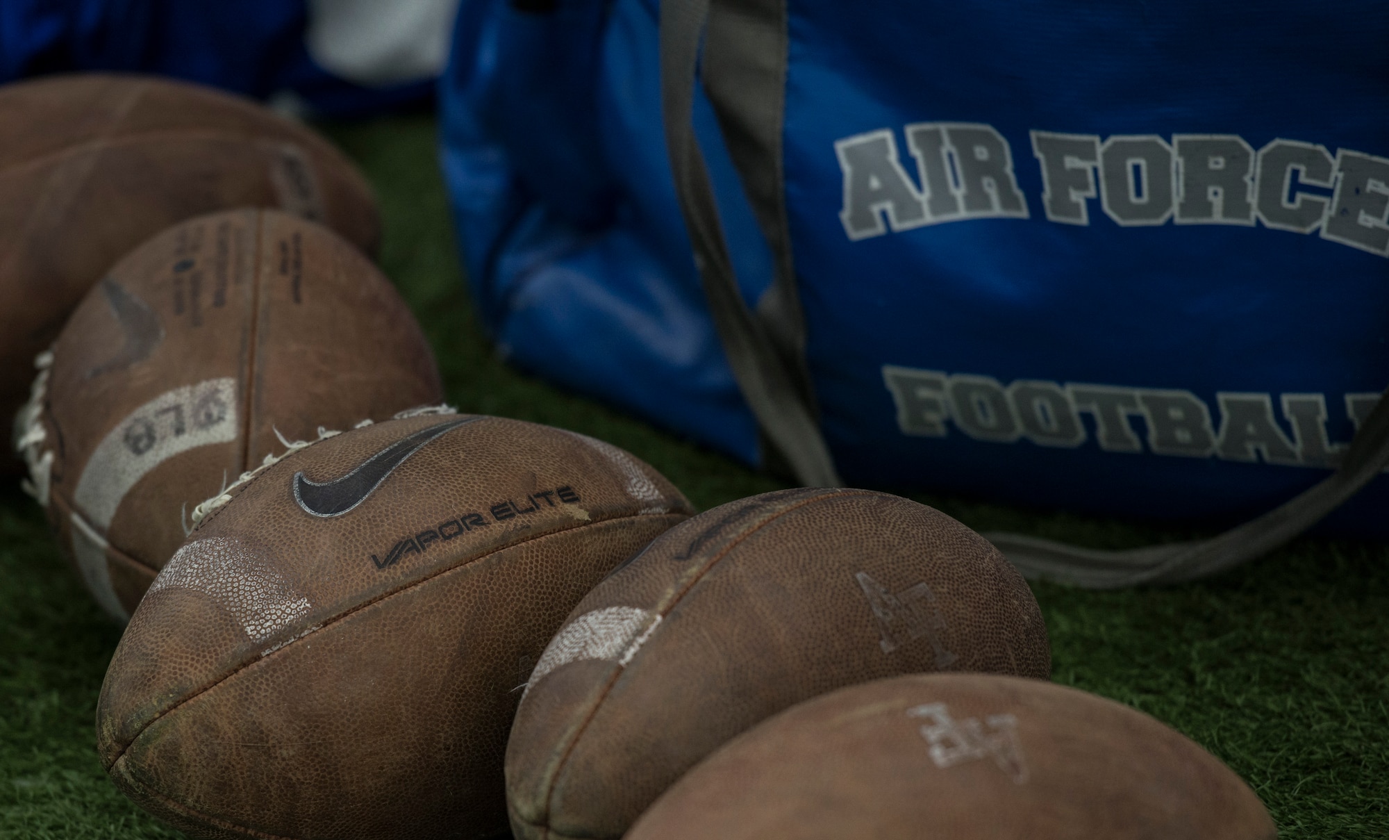 Spare footballs litter the sideline of the Caven Williams Sports Complex in Boise, Idaho, Dec. 17, 2014. The footballs have been battered and beaten by the Air Force Falcons in preparation for the upcoming Famous Idaho Potato Bowl. (U.S. Air Force photo by Airman 1st Class Jessica H. Smith/RELEASED)  
