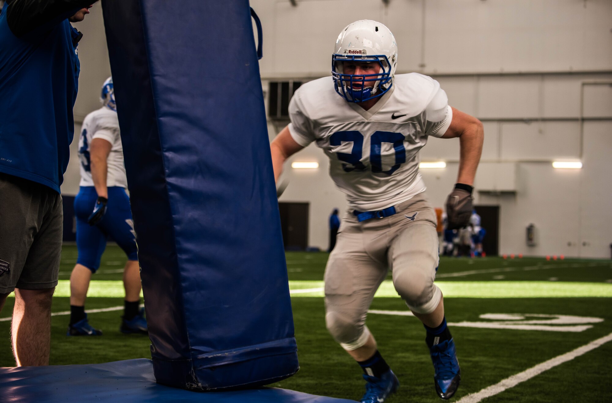 An Air Force Falcons player tackles a training dummy during practice Dec. 17, 2014, at the Caven Williams Sports Complex, Boise, Idaho.Training exercises with dummies are critical to perfecting form and precision.(U.S. Air Force photo by Airman Connor J. Marth/RELAESED)