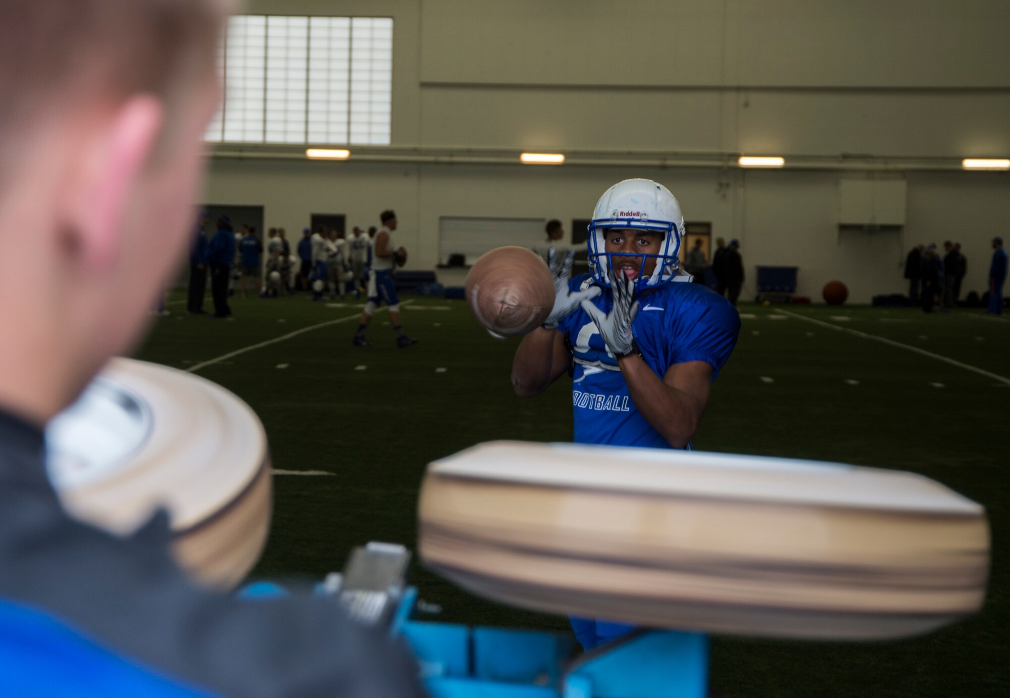 An Air Force Academy football player catches a football during practice Dec. 17, 2014, at the Caven Williams Sports Complex Boise, Idaho. The team is practicing for the Famous Idaho Potato Bowl which is Saturday, December 20, starting at 3:45 p.m. at Albertsons Stadium.  (U.S. Air Force photo by Staff Sgt. Roy Lynch/RELEASED)