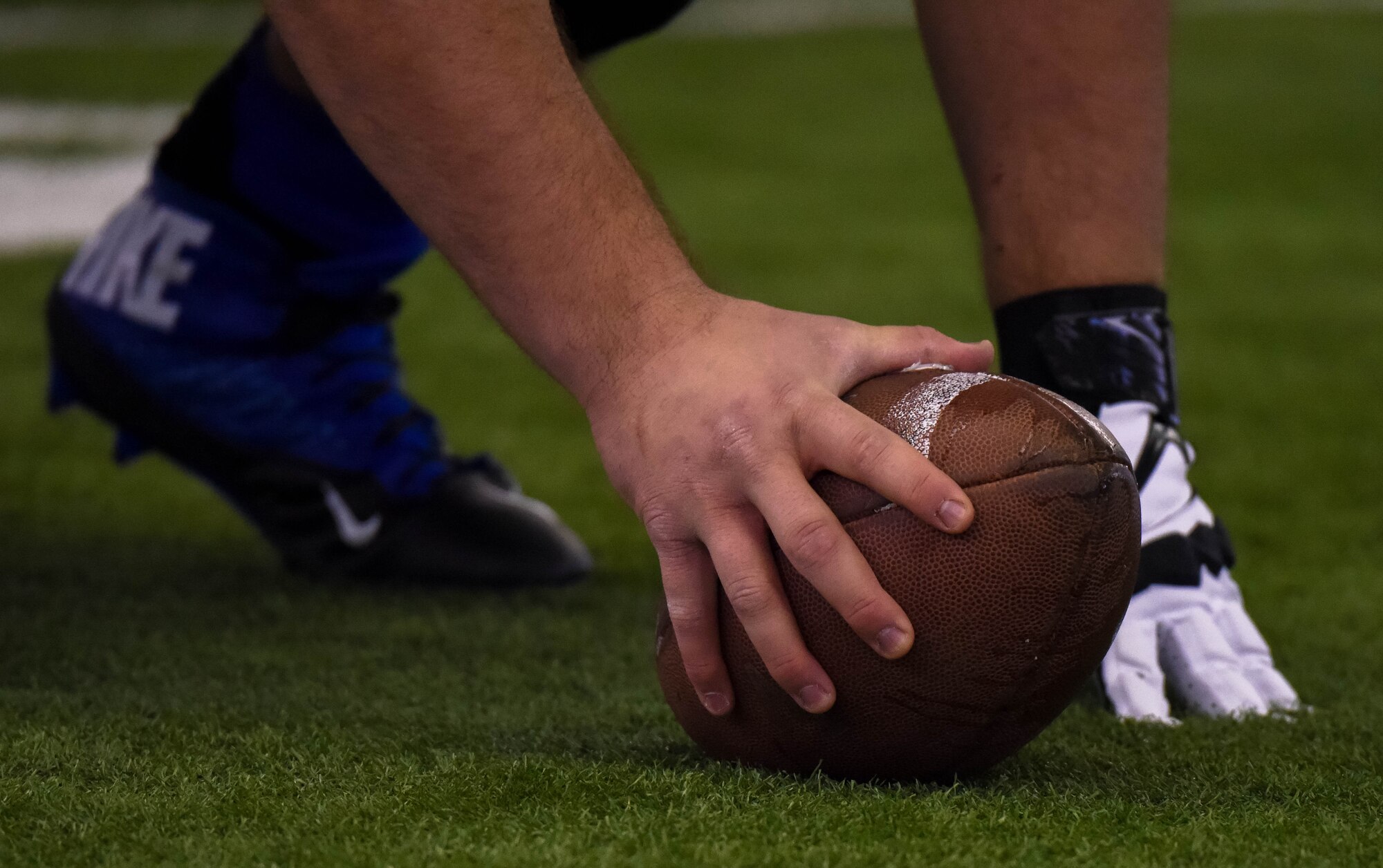 An Air Force Falcon player prepares to snap the football during practice Dec. 17, 2014, at the Caven Williams Sports Complex in Boise, Idaho. The Falcons are preparing for the 17th annual Famous Idaho Potato Bowl. (U.S. Air Force photo by Airman 1st Class Jeremy L. Mosier/RELEASED)