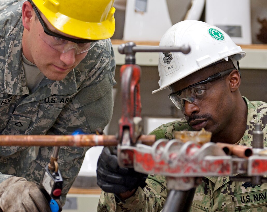 Navy Petty Officer 1st Class Charlie King, 366th Training Squadron
instructor, supervises Army Pfc. Ryan Sivahop, Delta Company 169th Engineer
Battalion, as he uses a blowtorch to solder copper pipe during a water and
fuel systems maintenance course plumbing class at Sheppard Air Force Base,
Texas, Dec. 5, 2014. Students troubleshoot plumbing systems and make repairs
so all fixtures operate properly. (U.S. Air Force Photo Danny Webb/Released)
