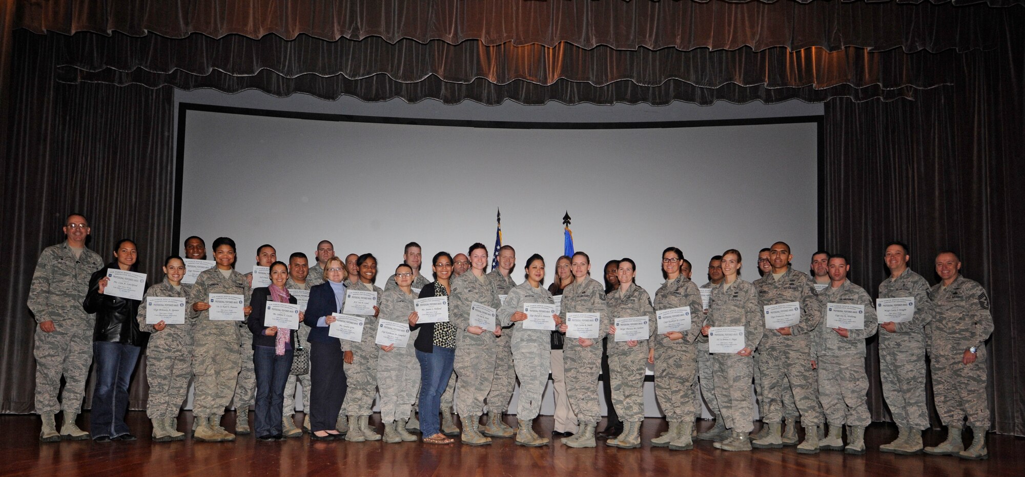 Col. Keith Balts, 30th Space Wing commander, and Chief Master Sgt. William “DJ” Jones, 30th SW command chief, recognize the professional performers of the wing’s Unit Effectiveness Inspection, Dec. 16, 2014, Vandenberg Air Force Base, Calif. The wing earned a rating of “Effective” in three of the four major graded areas; managing resources, leading people, improving the unit and earned “Very Effective” for the final graded area, primary mission. (U.S. Air Force photo by Airman Robert J. Volio/Released)