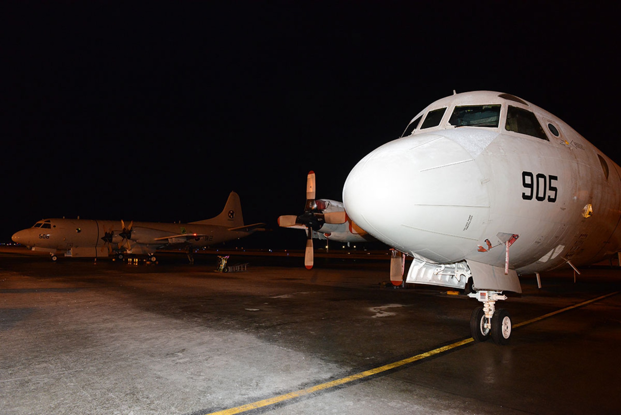 A pair of South Korean navy P3 Orion aircraft rest on the tarmac at Joint Base Elemendorf-Richardson near Anchorage, Alaska, prior to search operations for crewmembers from the fishing vessel 501 Oryong Dec. 9, 2014. Approximately 60 crewmembers were reported aboard the 501 Oryong when it sank in the Bering Sea Dec. 1. U.S. Coast Guard photo by Petty Officer 1st Class Shawn Eggert.