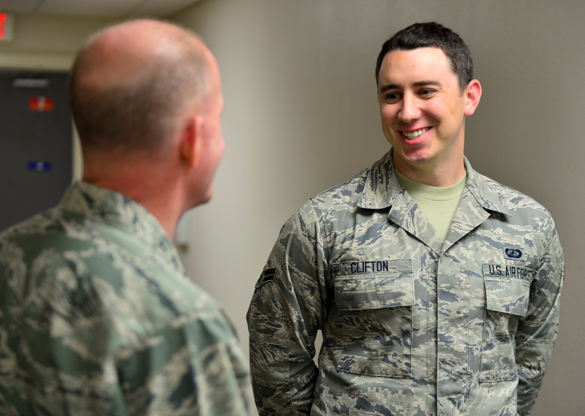 Lt. Gen. Stephen Wilson, commander of Air Force Global Strike Command, speaks with Airman 1st Class Mark Clifton, 2nd Contracting Squadron contract specialist, on Barksdale Air Force Base, La., Dec. 16, 2014. During his visit Wilson asked Airmen how he could help improve their working conditions and listened to their concerns. (U.S. Air Force photo/Airman 1st Class Mozer O. Da Cunha) 