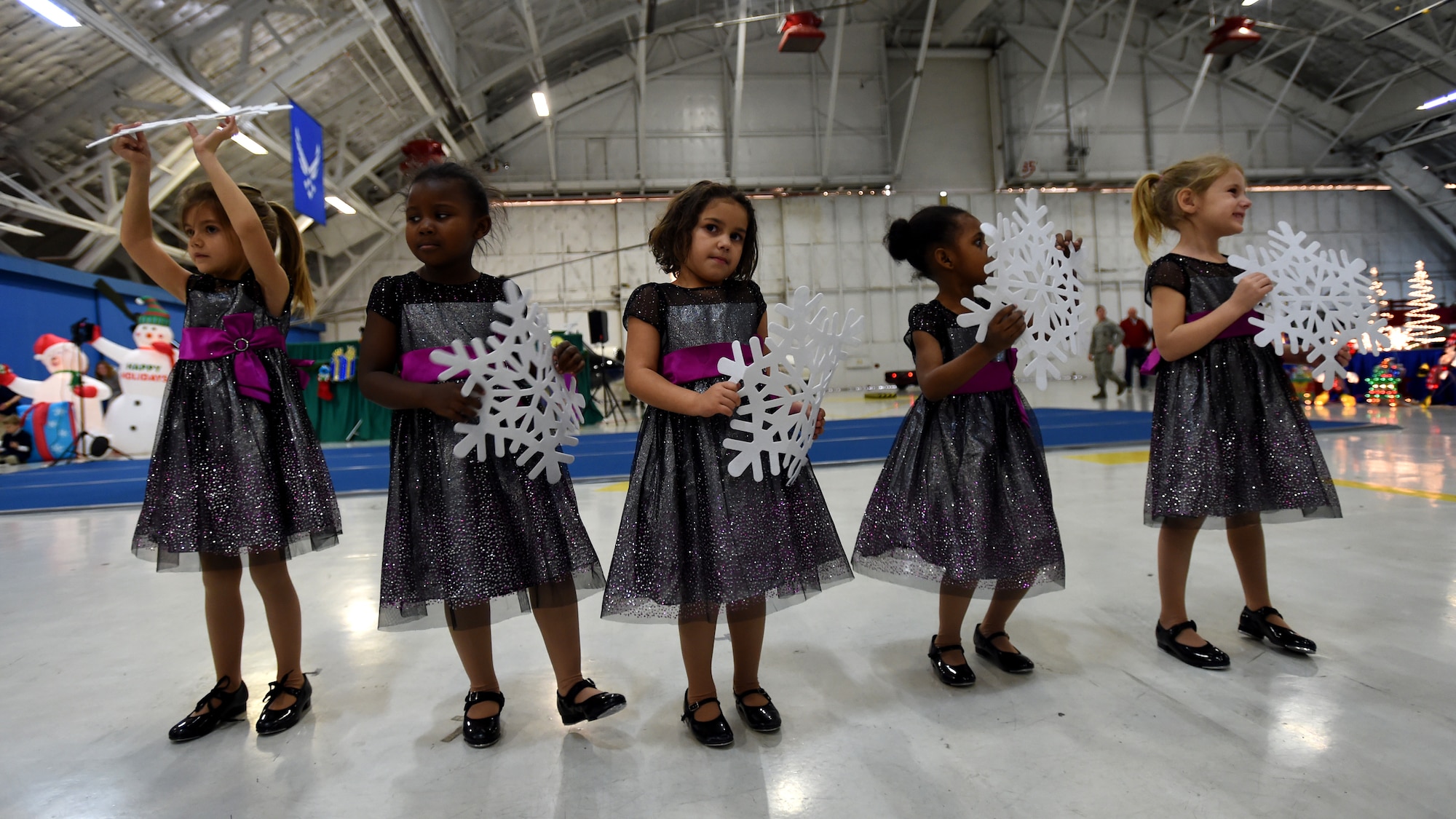 Attendees of the Parents and Children Fighting Cancer Holiday Party watch the Berryville Baptist Rascals’ puppet show on Joint Base Andrews, Md., Dec. 13, 2014.  The Rascals’ mission is to present programs with contemporary Christian, Sunday school, country and rock-and-roll music selections that share positive messages focusing on Christian values and kindness. (U.S. Air Force photo/ Senior Airman Nesha Humes)
