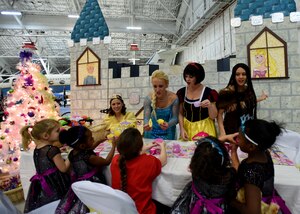 The Disney Princesses play tea party with attendees of the Parents and Children Fighting Cancer Holiday Party on Joint Base Andrews, Md., Dec. 13, 2014. More than 250 volunteers collaborated for the 27th annual event. (U.S. Air Force photo/ Senior Airman Nesha Humes) 