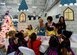 The Disney Princesses play tea party with attendees of the Parents and Children Fighting Cancer Holiday Party on Joint Base Andrews, Md., Dec. 13, 2014. More than 250 volunteers collaborated for the 27th annual event. (U.S. Air Force photo/ Senior Airman Nesha Humes) 