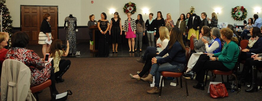 Members of the Barksdale Officers' Spouse's Club show various styles during a fashion show function on Barksdale Air Force Base, La., Dec. 9, 2014. The BOSC is a non-profit organization that fosters friendships and comradery amongst the spouses as well as helps build confidence and an understanding of the military lifestyle from the spousal perspective. (U.S. Air Force photo/Senior Airman Kristin High)
