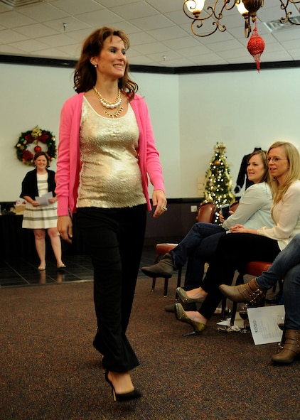 Kari Truskett, Barksdale Officers' Spouse's Club member, models during the monthly function on Barksdale Air Force Base, La., Dec. 9, 2014. The fashion show was held to show the spouses how to appropriately dress for certain events they will attend. (U.S. Air Force photo/Senior Airman Kristin High)