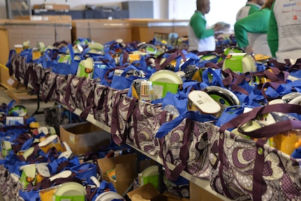 Hundreds of bags with all the ingredients for a holiday meal wait to be picked up by Airmen and Sailors, courtesy of Operation Homefront and various corporate sponsors Dec. 10, 2014, at Joint Base Charleston, S.C.  A national nonprofit, Operation Homefront leads more than 2,500 volunteers with nationwide presence who provide emergency and other financial assistance to the families of service members and wounded warriors. Operation Homefront has provided assistance to thousands of military families since its inception in 2002. (U.S. Air Force photo/Eric Sesit)