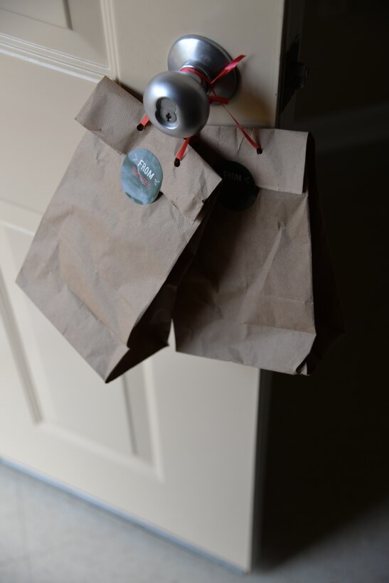 Bags of cookies hang on a student’s door; they were delivered by the Laughlin Spouses’ Club as part of the Cookie Caper event at Laughlin Air Force Base, Texas, Dec. 11, 2014. Almost 5,000 cookies were collected and delivered to Laughlin airmen. (U.S. Air Force photo by 2nd Lt. Aaron Redfield) (Released)