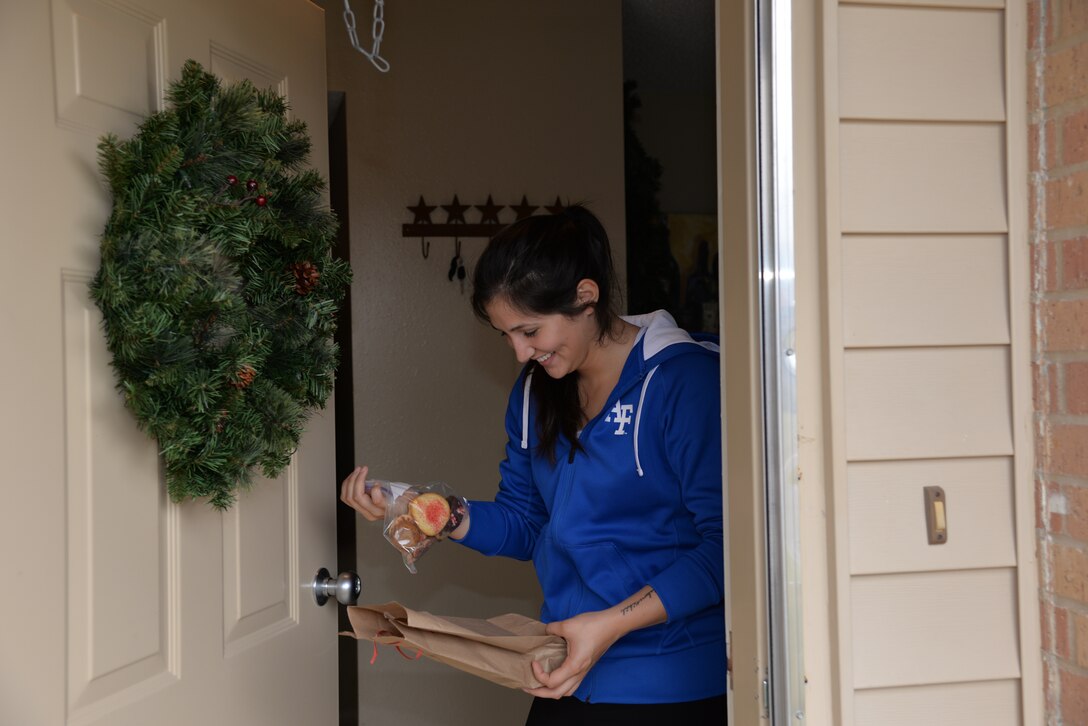Second Lt. Victoria Perkins, along with hundreds of other airmen, receives a special package of cookies from the Laughlin Spouses’ Club at Laughlin Air Force Base, Texas, Dec. 11, 2014. The LSC delivered cookies to Laughlin airmen as part of the annual Cookie Caper event. (U.S. Air Force photo by 2nd Lt. Aaron Redfield) (Released)