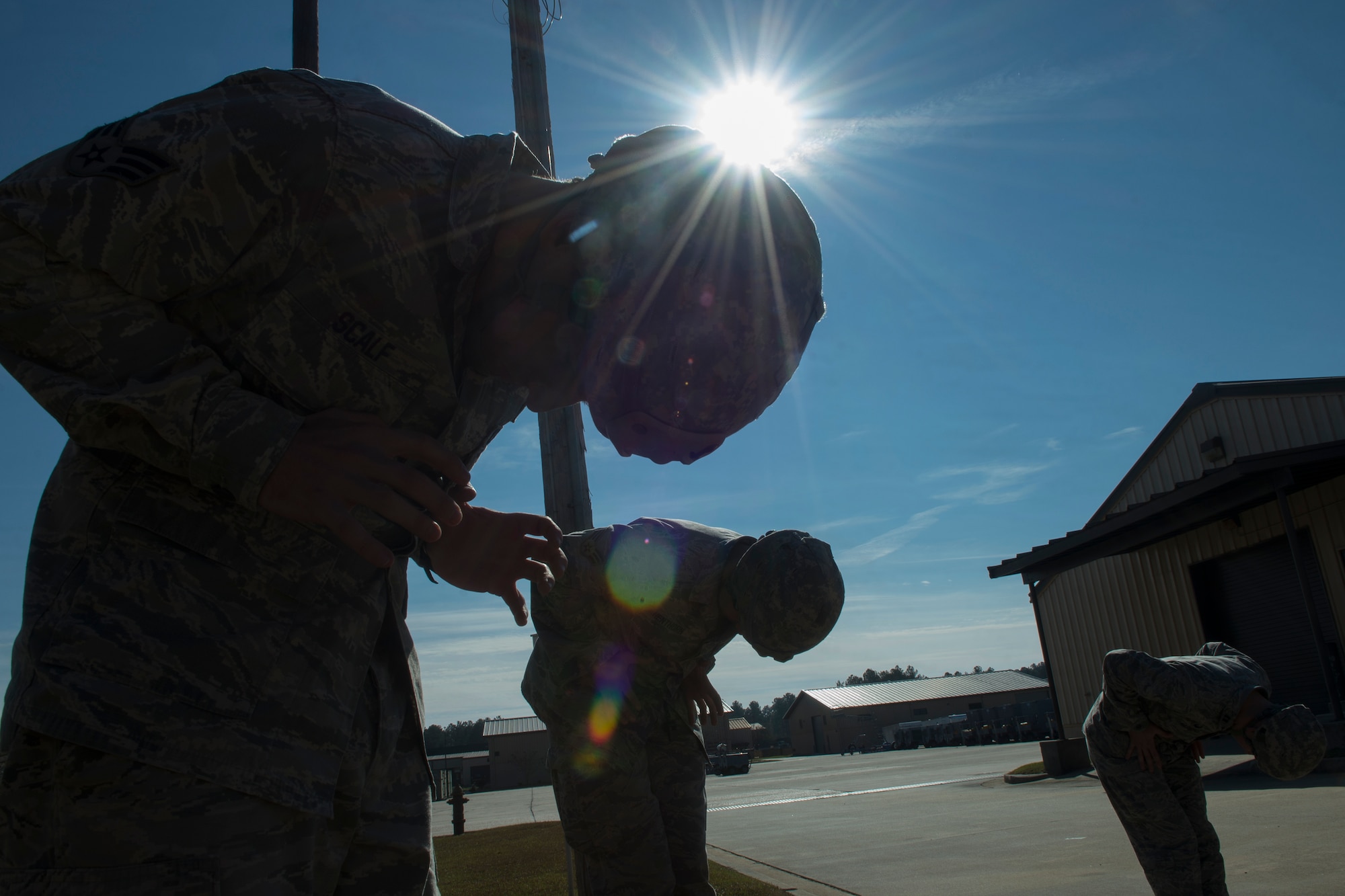 U.S. Air Force Senior Airman Alexander Scalf, 820th Base Defense Group, simulates looking for parachute deficiencies during pre-jump training Dec. 11, 2014, at Moody Air Force Base, Ga. Members of the 820th BDG practiced emergency landings and safety procedures to prepare for a static-line jump. (U.S. Air Force photo by Senior Airman Sandra Marrero/Released)

