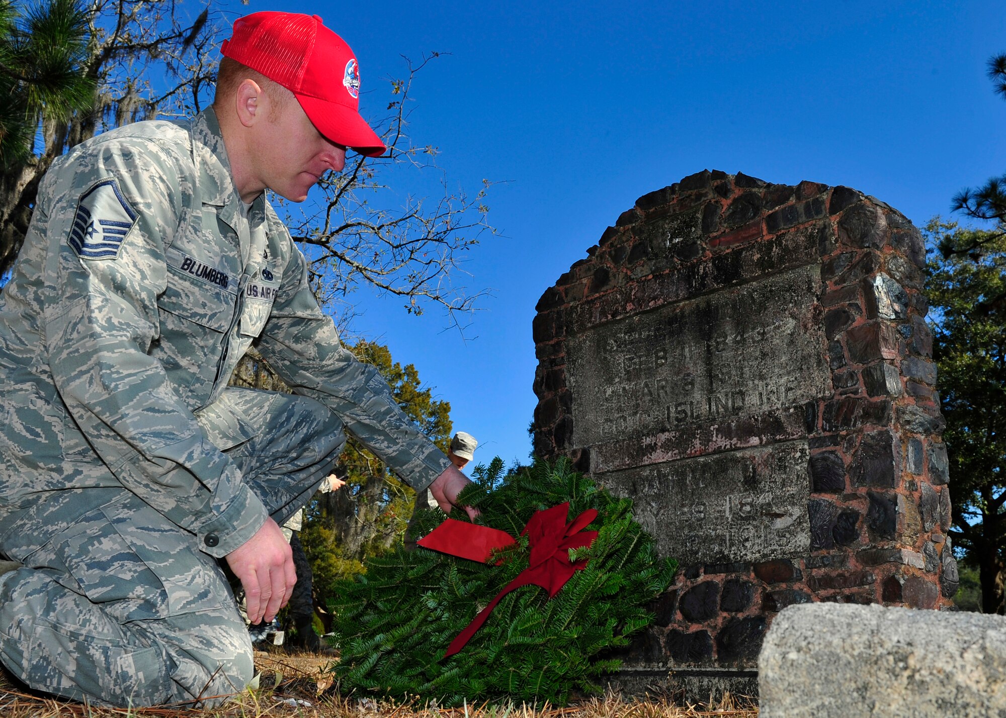 Master Sgt. Ryan Blumberg, 823rd RED HORSE expeditionary manpower management course instructor, lays a wreath on a veterans grave Dec. 13 at the Mount Hope Cemetery in Lynn Haven, Fla. Blumberg laid the wreath as part of the Wreaths Across America Day event, that pays respect and honor to military members that have fallen. (U.S. Air Force photo by Airman 1st Class Sergio A. Gamboa) 