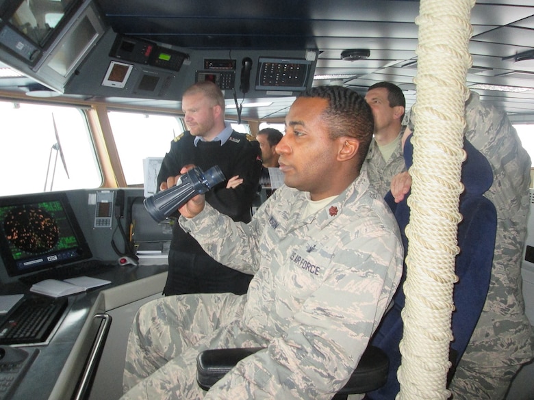 Maj. Jarrell Lawson, 23rd Space Operations Squadron Detachment 1 commander, sits on the bridge of the HDMS Knud Rassmussen Sept. 28, 2014. Lawson toured the Danish navy patrol ship along with several Thule leaders as part of a familiarization event with their Danish military counterparts. (U.S. Air Force/courtesy photo) 