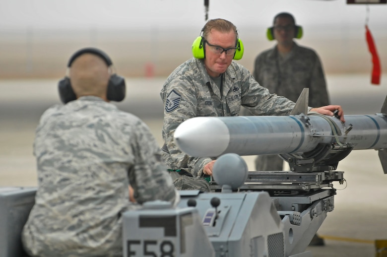 U.S. Air Force Airman Master Sgt. David Gaskins works as a weapons load crew member during a  load crew challenge for Valiant Eagle 2014 at the 125th Fighter Wing, Jacksonville, Fla. on December 5, 2014 (U.S. Air National Guard photo by Staff Sgt. Troy Anderson // Released)