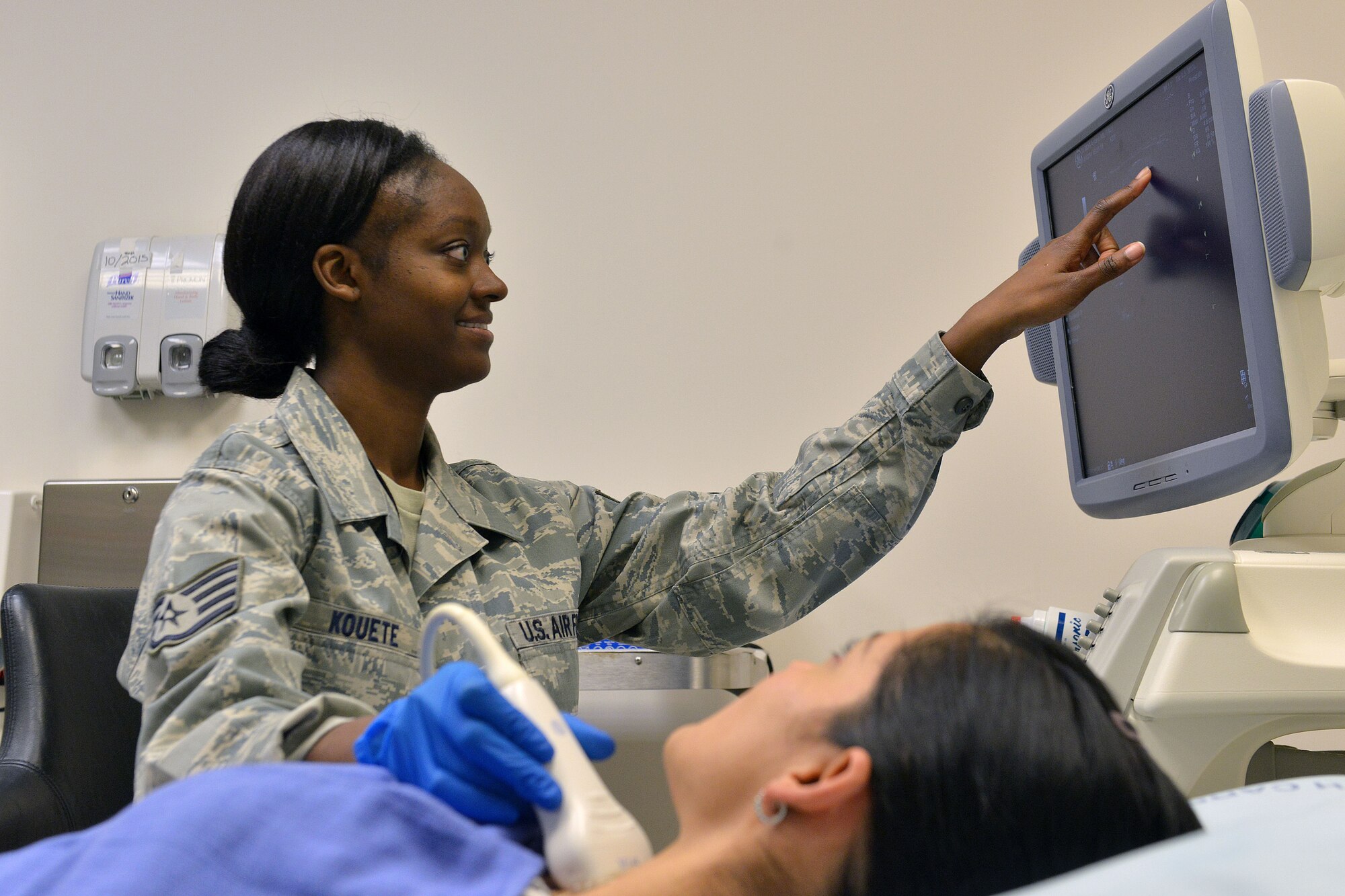 Staff Sgt. Kimberly Kouete, 31st Surgical Operations Squadron ultrasound technician, performs an ultrasound of a patient’s throat, Dec. 3, 2014, at Aviano Air Base, Italy. An ultrasound is commonly used to track pregnancies, but can be used to visualize muscles, tendons and many internal organs to capture their size and structure. (U.S. Air Force photo/Airman 1st Class Ryan Conroy) 
