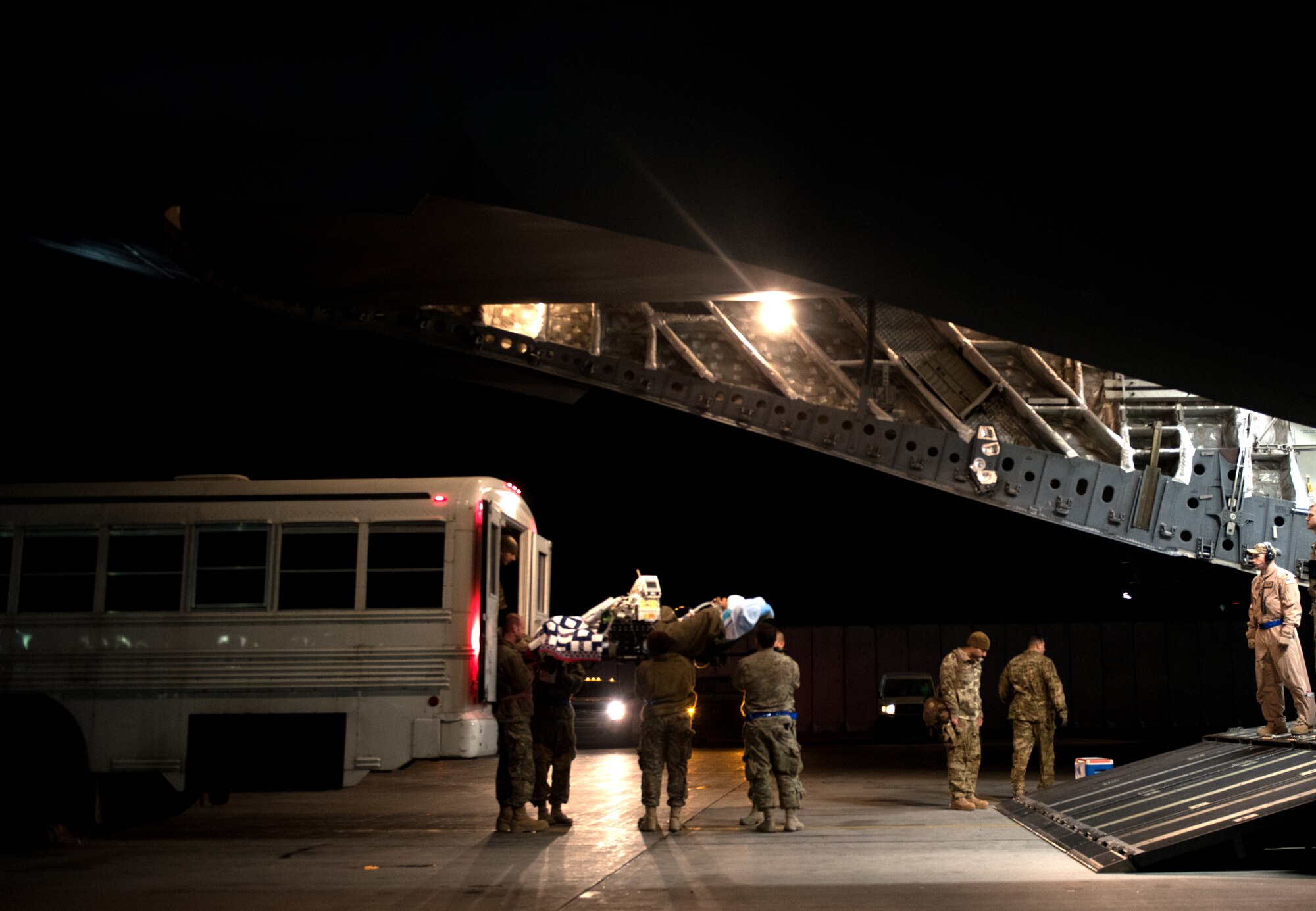 Litter bearers from the 455th Expeditionary Aeromedical Evacuation Squadron carry a patient onto a C-17 Dec. 14, 2014. The 455th EAES works with the 10th Expeditionary Aeromedical Evacuation Squadron to transport patients from deployed locations to receive medical care. (U.S. Air Force photo/Staff Sgt. Katherine Tereyama/RELEASED)