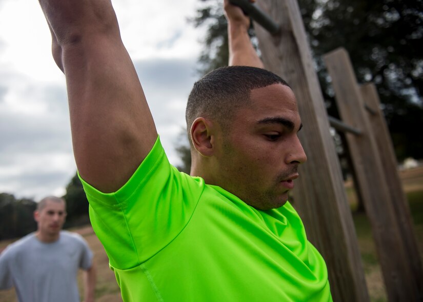 Staff Sgt. Robert Gallagher, a 560th Red Horse Squadron reservist, hangs on a pull-up bar during a practice Physical Ability and Stamina Test Dec. 9, 2014, at Joint Base Charleston, S.C.,. The event was hosted by Tech. Sgt. Ismael Villegas, a combat controller who is a two-time Silver Star recipient and an Air Force Special Operations Command in service recruiter. (U.S. Air Force 