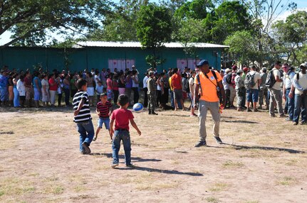 U.S. Air Force Capt. Troy Lane, Joint Task Force – Bravo commander’s adjutant, plays soccer with children from the village of Mira Valle, La Paz, Honduras, Dec. 13, 2014. The soccer balls were donated by the non-profit organization Kick for Nick Foundation. As part of the 58th Chapel Hike, 167over 130 members assigned to Joint Task Force-Bravo trekked over three miles to help deliver over 3,5002,500-pounds of donated dry goods to villagers in need. Since the chapel hikes originated in 2007, over 9,700 service members have donated over $170,000 and volunteered their time to deliver more than 209,000 pounds of food and supplies to several remote villages. (U.S. Air Force photo/Capt. Connie Dillon)