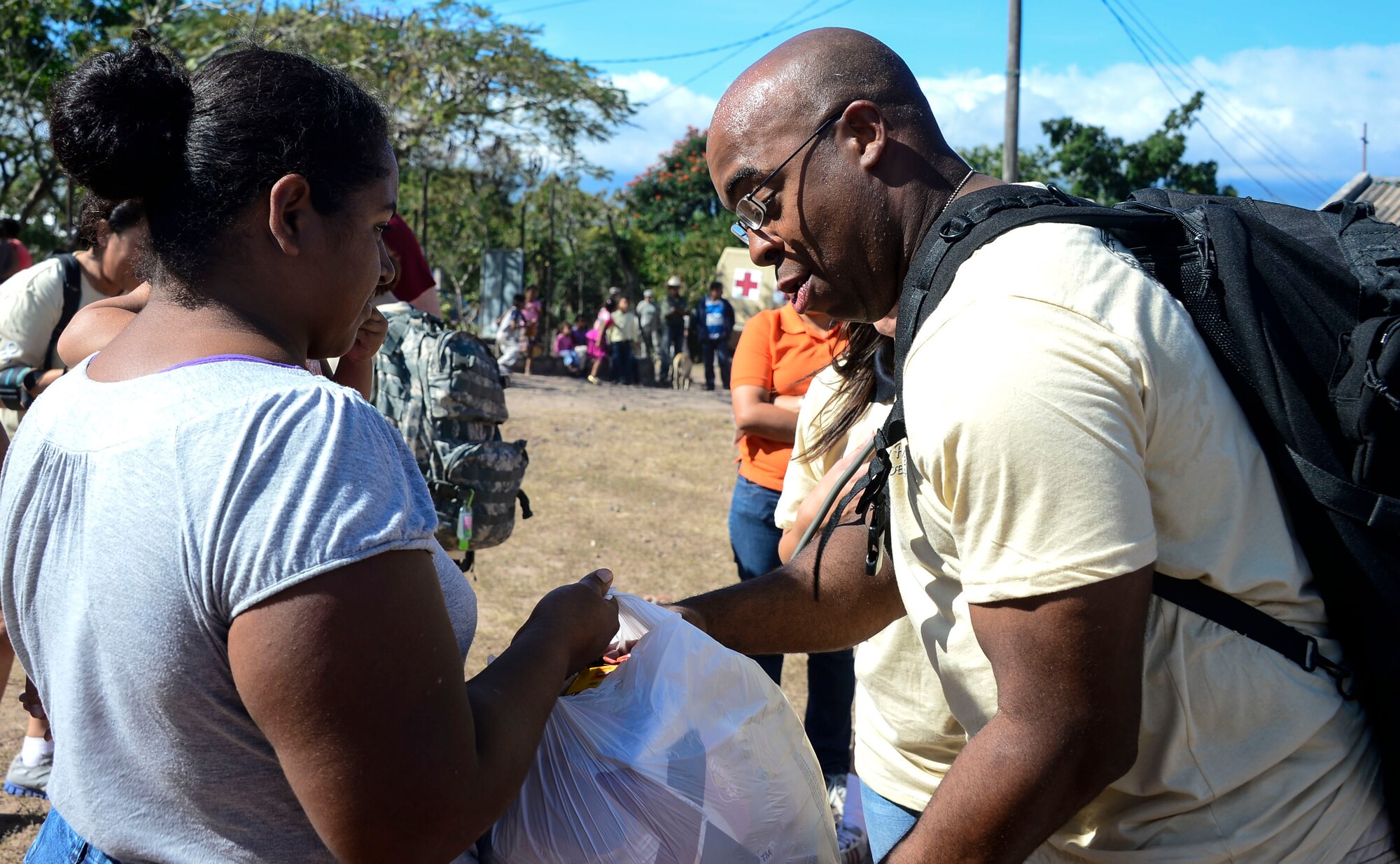 U.S. Army Master Sgt. Leon Fletcher, Medical Element first sergeant, gives one of the villagers a bag of donated food during the 58th Chapel Hike in the village of Mira Valle, La Paz, Honduras, Dec. 13, 2014. As part of the 58th Chapel Hike, over 130167 members assigned to Joint Task Force-Bravo trekked over three miles to help deliver over 3,5002,500-pounds of donated dry goods to villagers in need. Since the chapel hikes originated in 2007, over 9,700 service members have donated over $170,000 and volunteered their time to deliver more than 209,000 pounds of food and supplies to several remote villages. (U.S. Air Force photo/Tech. Sgt. Heather Redman)