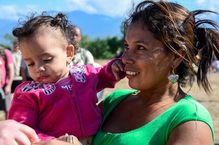 A villager thanks a volunteer for a bag of donated food during the 58th Chapel Hike in the village of Mira Valle, La Paz, Honduras, Dec. 13, 2014. As part of the 58th Chapel Hike, over 130167 members assigned to Joint Task Force-Bravo trekked over three miles to help deliver over 3,5002,500-pounds of donated dry goods to villagers in need. Since the chapel hikes originated in 2007, over 9,700 service members have donated over $170,000 and volunteered their time to deliver more than 209,000 pounds of food and supplies to several remote villages. (U.S. Air Force photo/Tech. Sgt. Heather Redman)