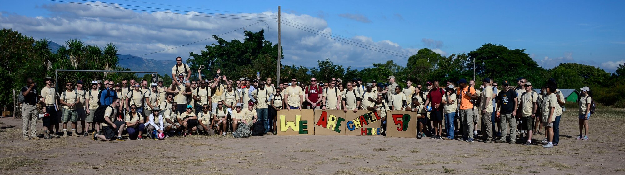Volunteers gather for a photo during the 58th Chapel Hike in the village of Mira Valle, La Paz, Honduras, Dec. 13, 2014. As part of the 58th Chapel Hike, over 130167 members assigned to Joint Task Force-Bravo trekked over three miles to help deliver over 3,5002,500-pounds of donated dry goods to villagers in need. Since the chapel hikes originated in 2007, over 9,700 service members have donated over $170,000 and volunteered their time to deliver more than 209,000 pounds of food and supplies to several remote villages. (U.S. Air Force photo/Tech. Sgt. Heather Redman)