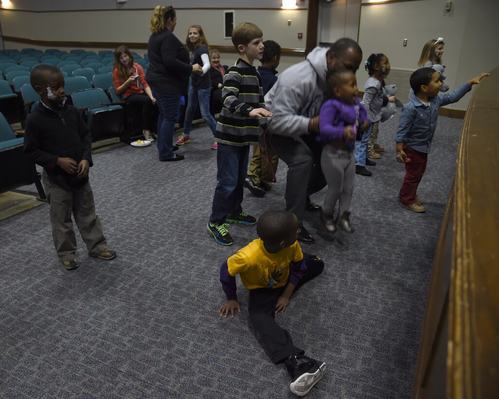 Attendees play freeze dance at the Hearts Apart Deployed Families Holiday Party at Joint Base Andrews, Dec. 13, 2014. The event featured activities and food for the families of deployed, TDY or remotely-located service members. (U.S. Air Force photo/Airman 1st Class J.D. Maidens)