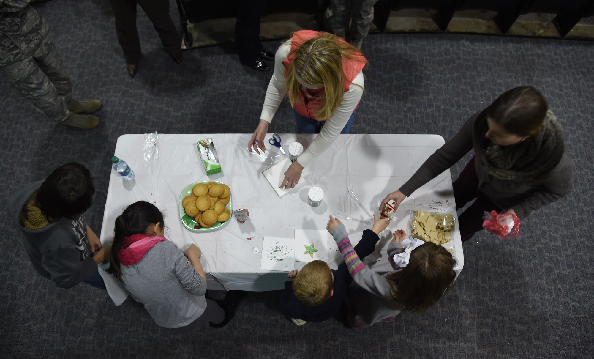 Families of service members decorate cookies at the Hearts Apart Deployed Families Holiday Party, Dec. 13, 2014. The annual event brought together families from all branches dealing with deployment or future deployment, TDY or remotely-located over the holiday season. (U.S. Air Force photo/Airman 1st Class J.D. Maidens)