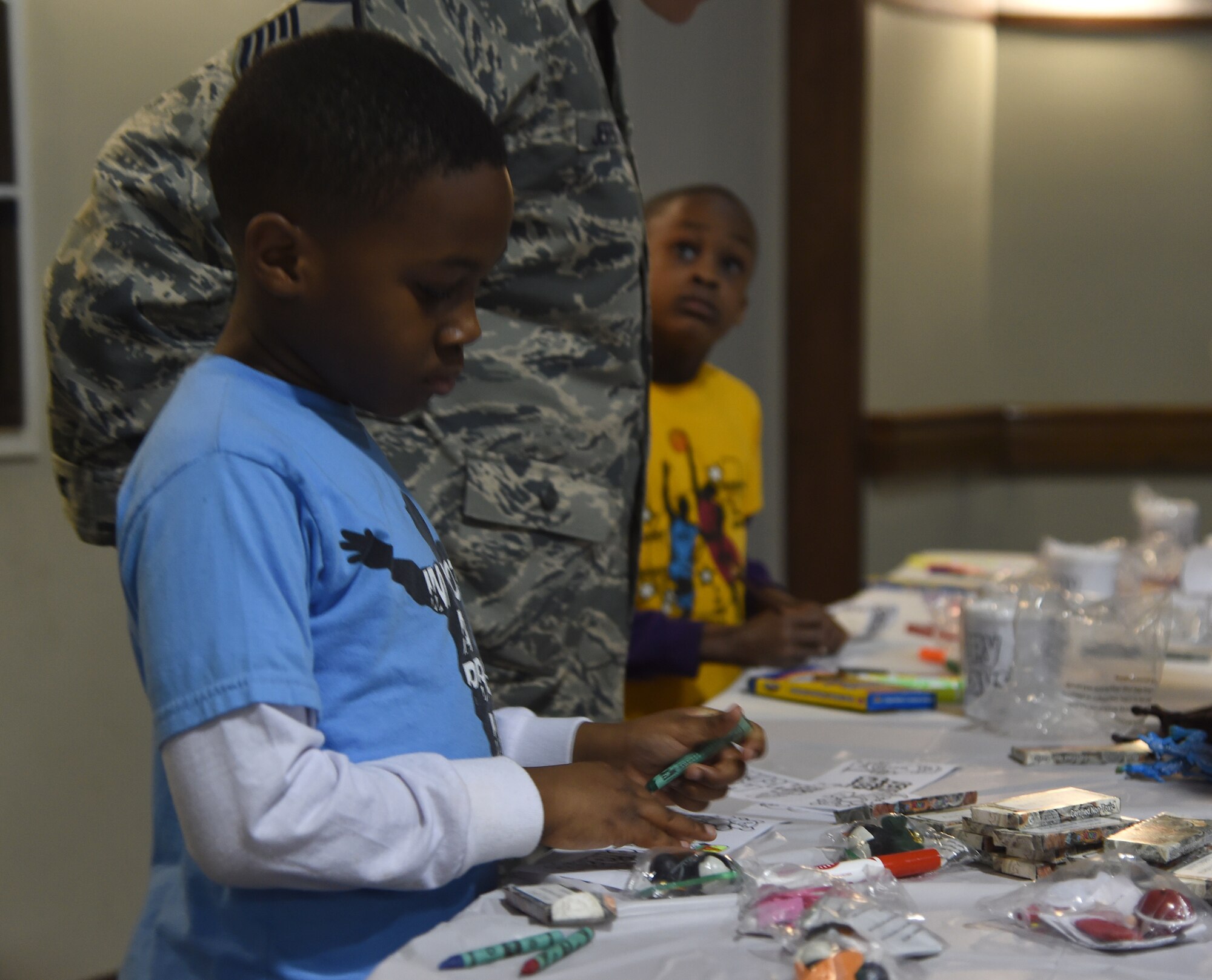 Brandon Reynolds, son of a deployed service member, draws pictures for a care package at the Hearts Apart Deployed Families Holiday Party, Dec. 13, 2014. The event featured activities and food for the families of deployed, TDY or remotely-located service members. (U.S. Air Force photo/Airman 1st Class J.D. Maidens)