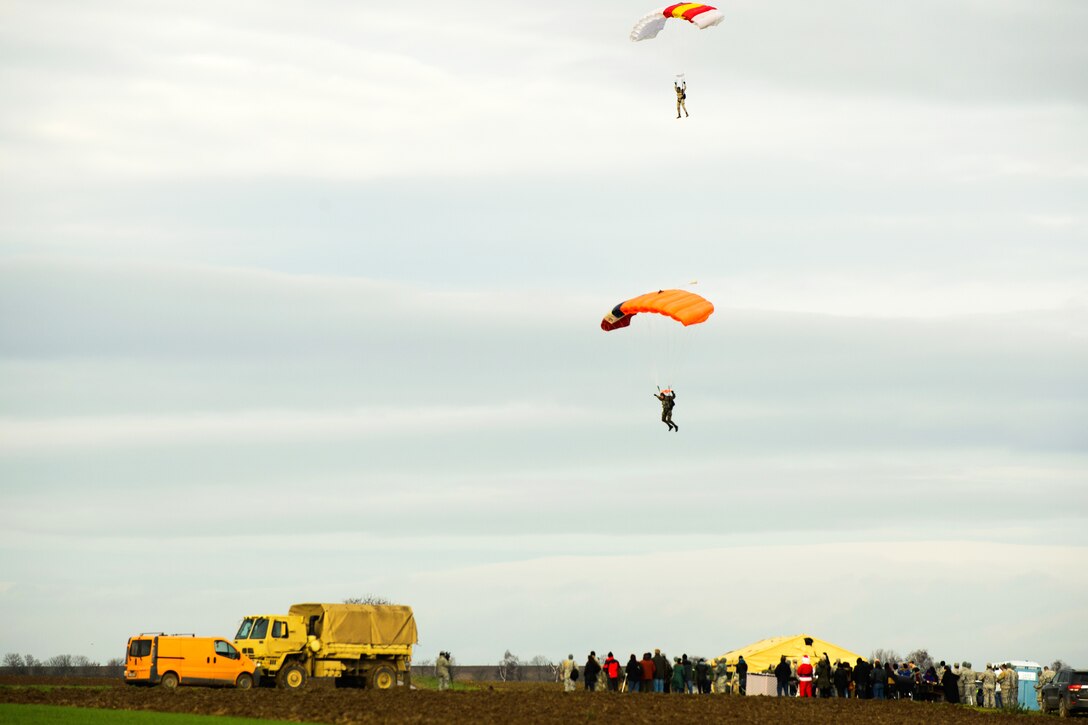 NATO partner paratroopers guide thier parachute toward the Alzey drop zone, Germany, Dec. 15, 2104.