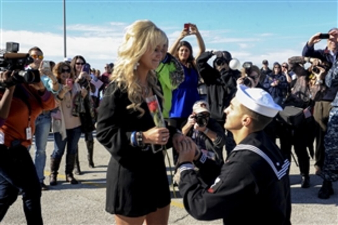 Navy Petty Officer 3rd Class Caleb Strother proposes to Brittney Apperson during a homecoming ceremony for the guided-missile frigate USS Samuel B. Roberts in Mayport, Fla., Dec. 15, 2014.