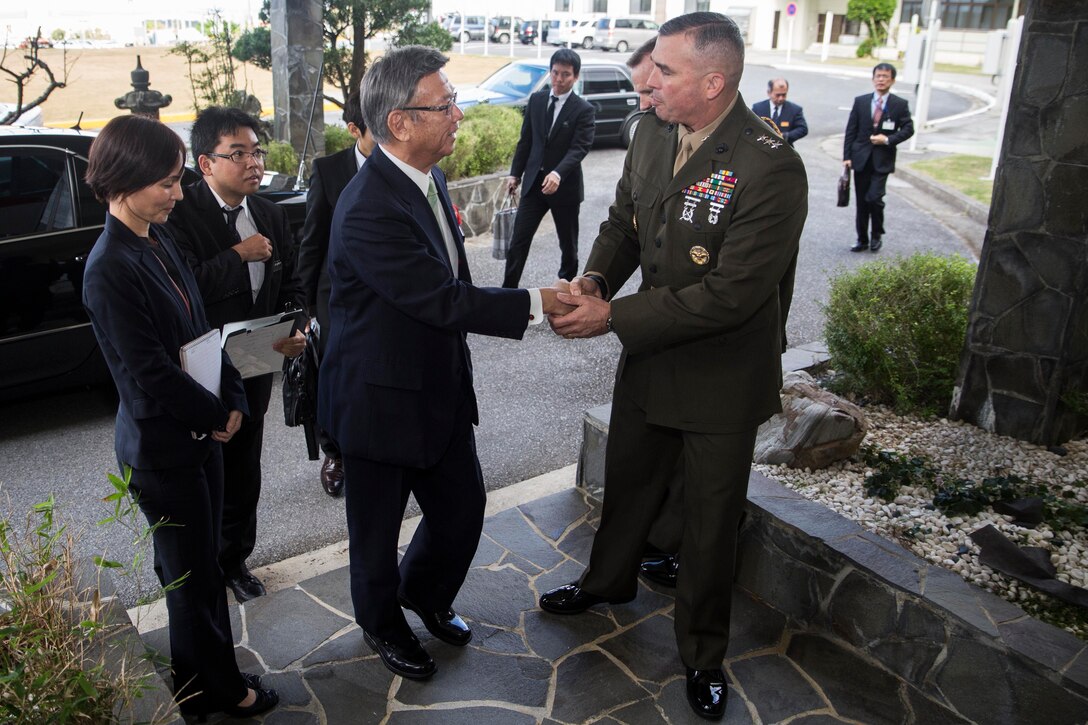 Takeshi Onaga, newly-elected Okinawa governor, left, shakes hands with Lt. Gen. John Wissler, Okinawa area coordinator, U.S. Forces Japan, during their first meeting December 18 at Marine Corps Installation Pacific headquarters Building One, Camp Foster. Onaga and Wissler exchanged greetings and discussed bolstering relationships between the Okinawan government, citizens and U.S. forces in Okinawa. Wissler is also the III Marine Expeditionary Force commanding general. 