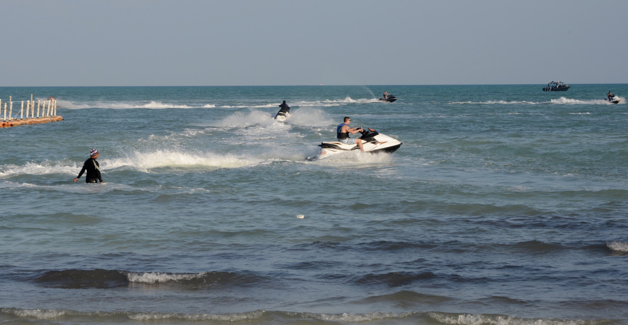 U.S. servicemembers ride jet skis during the Qatari Minister of Defense’s Beach House event, Dec. 15, 2014, near Al Khor, Qatar. Qatar Minister of Defense, Maj. Gen. Hamad Al-Attiyah, invites U.S. servicemembers deployed to Al Udeid Air Base and Camp As Sayliyah, Qatar; their families, as well as Department of Defense civilians, to his beach house every a year as a gesture of friendship and good will.  Some of the activities at the beach house event included deep sea fishing, Qatari tea, camel rides and hookah. (U.S. Air Force photo by Senior Airman Kia Atkins)