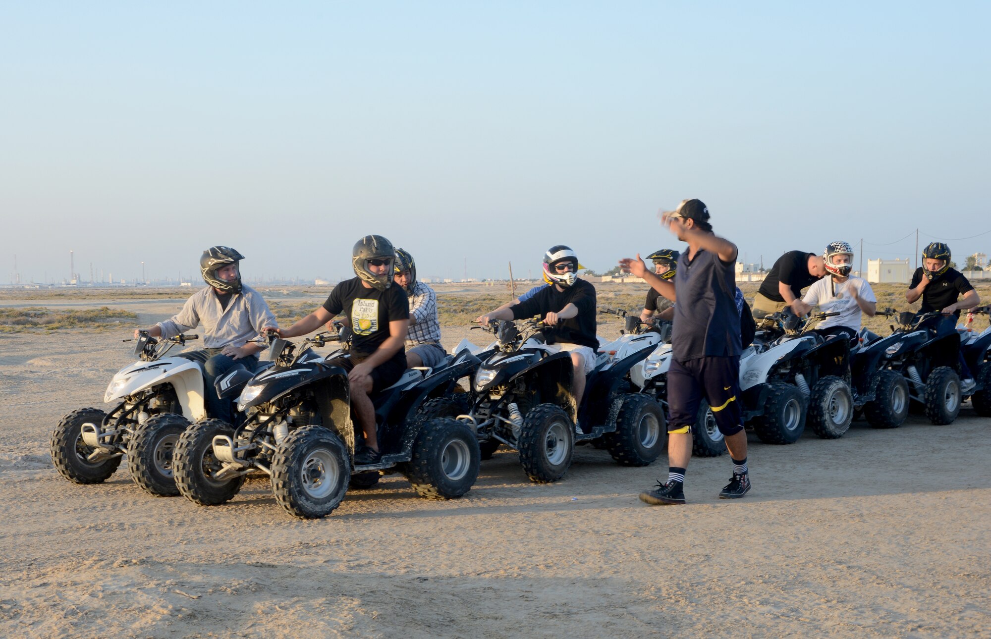 U.S. servicemembers listen to a safety brief before riding four-wheelers during the Qatari Minister of Defense’s Beach House event, Dec. 15, 2014, near Al Khor, Qatar. Qatar Minister of Defense, Maj. Gen. Hamad Al-Attiyah, invites U.S. servicemembers deployed to Al Udeid Air Base and Camp As Sayliyah, Qatar; their families, as well as Department of Defense civilians, to his beach house every a year as a gesture of friendship and good will.  Some of the activities at the beach house event included deep sea fishing, Qatari tea, camel rides and hookah. (U.S. Air Force photo by Senior Airman Kia Atkins)
