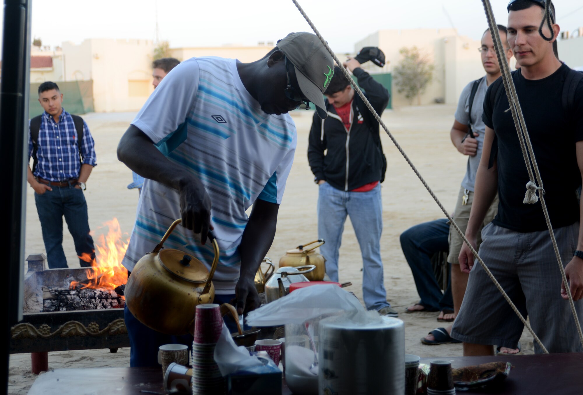 U.S. servicemembers wait in line for tea during the Qatari Minister of Defense’s Beach House event, Dec. 15, 2014, near Al Khor, Qatar. Qatar Minister of Defense, Maj. Gen. Hamad Al-Attiyah, invites U.S. servicemembers deployed to Al Udeid Air Base and Camp As Sayliyah, Qatar; their families, as well as Department of Defense civilians, to his beach house every a year as a gesture of friendship and good will.  Some of the activities at the beach house event included deep sea fishing, Qatari tea, camel rides and hookah. (U.S. Air Force photo by Senior Airman Kia Atkins)