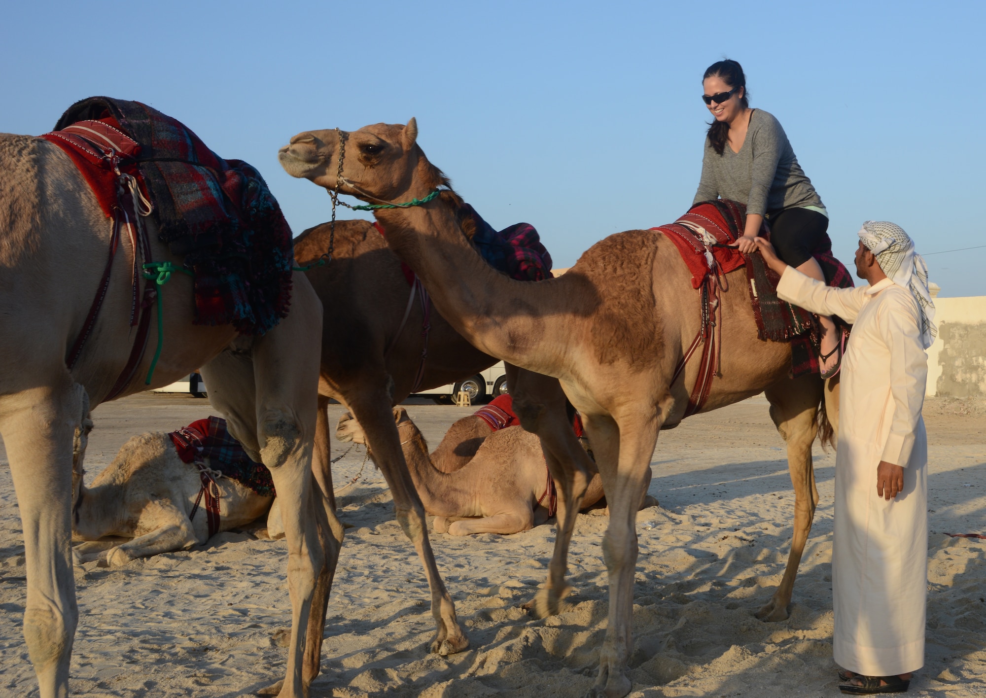 U.S. Air Force Staff Sgt. Mariko Frazee, 379th Air Expeditionary Wing public affairs broadcaster, rides a camel during the Qatari Minister of Defense’s Beach House event, Dec. 15, 2014, near Al Khor, Qatar. Qatar Minister of Defense, Maj. Gen. Hamad Al-Attiyah, invites U.S. servicemembers deployed to Al Udeid Air Base and Camp As Sayliyah, Qatar; their families, as well as Department of Defense civilians, to his beach house every a year as a gesture of friendship and good will. Some of the activities at the beach house event included deep sea fishing, Qatari tea, camel rides and hookah. Frazee is deployed from Maxwell Air Force Base, Ala. (U.S. Air Force photo by Senior Airman Kia Atkins)