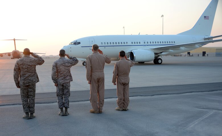 U.S. Air Forces Central Command and 379th Air Expeditionary Wing leadership salute the aircraft transporting Air Force Chief of Staff Gen. Mark A. Welsh III, Dec. 13, 2014, at Al Udeid Air Base, Qatar. During his visit to Al Udeid, Welsh spoke with Airmen about ongoing Air Force issues and emphasized key points such as mission focus and knowing your people. (U.S. Air Force photo by Senior Airman Kia Atkins)
