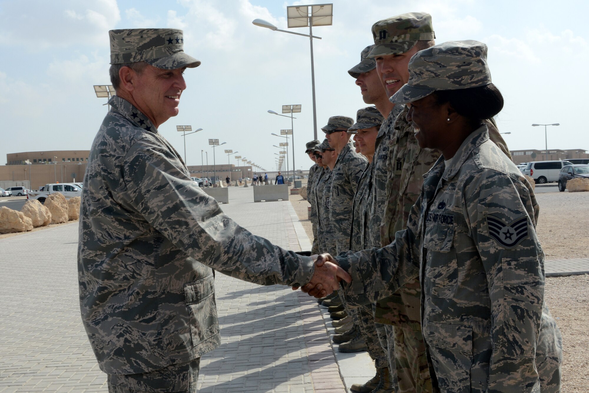 U.S. Air Force Chief of Staff Gen. Mark A. Welsh III, left, greets Airmen before attending a luncheon during his visit, Dec. 14, 2014, at Al Udeid Air Base, Qatar. Six Airmen assigned to Al Udeid were hand-picked to be coined by the CSAF for their hard work and dedication to the mission. (U.S. Air Force photo by Senior Airman Kia Atkins)