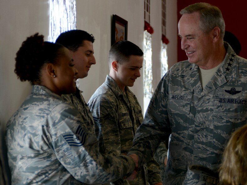 U.S. Air Force Chief of Staff Gen. Mark A. Welsh III, right, shakes hands with 379th Air Expeditionary Wing Airmen during a luncheon Dec. 14, 2014, at Al Udeid Air Base, Qatar. During the luncheon, Airmen shared their personal and professional stories with Welsh. (U.S. Air Force photo by Senior Airman Kia Atkins)