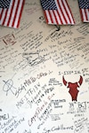 Names and messages are scribbled on the wounded warrior wall at the contingency aeromedical staging facility at Joint Base Balad, Iraq