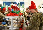Soldiers deployed to Afghanistan in support of Operation Enduring Freedom are served Christmas dinner from their command group at Bagram Airfield, Dec. 25, 2012. Maintaining communication with family and battle buddies is important in helping a Soldier stay resilient and connected when deployed, said a master resilience trainer.
