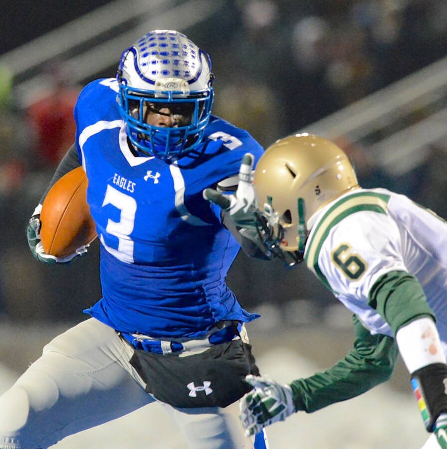 Semper Fidelis All-American Bowl selectee, Larry “LJ” Scott runs past a St. Vincent St. Mary defender on his way to the end zone in his last football game as a Hubbard Eagle. Though Hubbard lost the game 26-23, Scott rushed for 216 yards and two touchdowns. Scott rushed for 7476 yards and 98 touchdowns over the course of his four-year high school football career. He has chosen to attend Michigan State University, where he will play football for the Spartans next fall. (U.S. Marine Corps photo by Sgt. Timothy Stewmam/Released)
