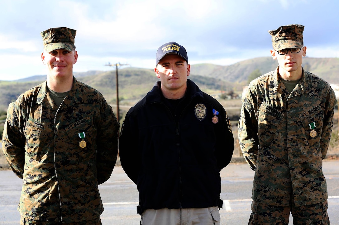 CAMP PENDLETON, Calif. -- Sgt. Daniel E. Norris, Officer Russell Palmeri and Cpl. Lance F. Bryant were presented with the Navy and Marine Corps Commendation Medal for meritorious service and the Navy Meritorious Civilian Service award, for heroic actions that saved the life of a Marine, at the Military Police Department headquarters building here, Dec. 17. 

Norris and Bryant are military police patrolmen and Palmeri is a civilian police officer with the Marine Corps Police Department, Security and Emergency Services Battalion here.

(Lance Cpl. Asia J. Sorenson)
