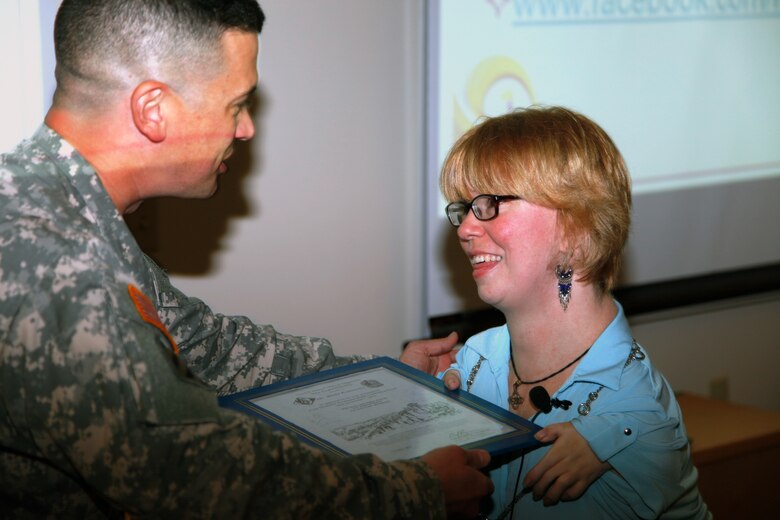 Sheila Radziewicz, receives the New England District Bunker Hill Award for her presentation at the Disabilities Awareness event.