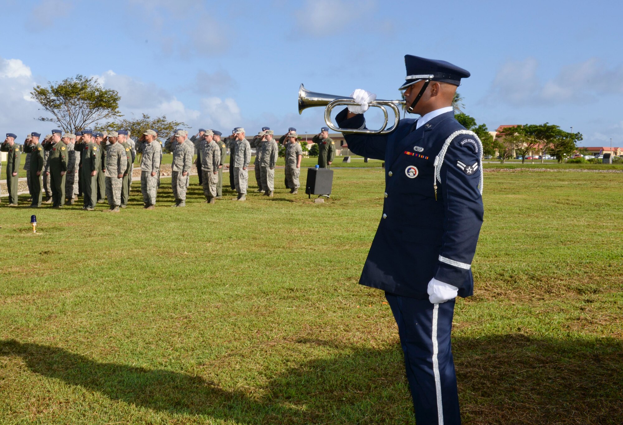 Airman 1st Class Anthony Smith-Nelson, Andersen Air Force Base Honor Guard, plays taps during the Operation Linebacker II Remembrance Ceremony Dec. 18, 2014, at Andersen AFB, Guam. The ceremony commemorated the 75 Airmen that lost their lives during the operation including 33 who were lost from 15 downed B-52 Stratofortress bombers.(U.S. Air Force photo by Staff Sgt. Robert Hicks/Released)  